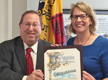 Councilmember Paul Koretz presents proclamation to Riddick president Maura Howe